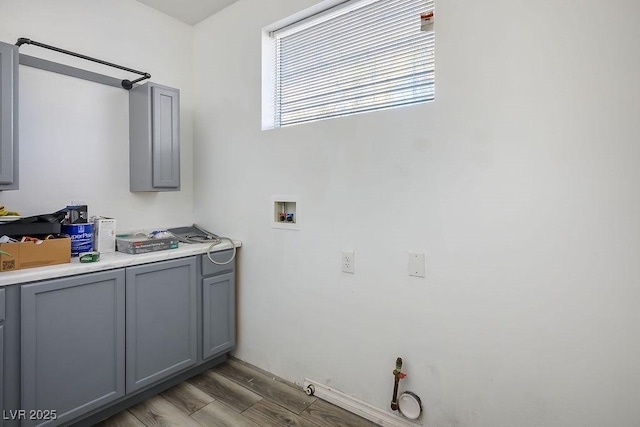 washroom with hookup for a washing machine, light wood-type flooring, and hookup for a gas dryer