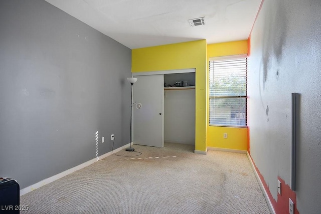 unfurnished bedroom featuring light colored carpet