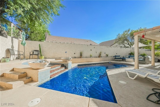 view of swimming pool with a patio and pool water feature