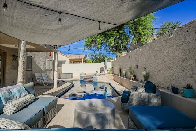 view of swimming pool with a patio and an outdoor living space