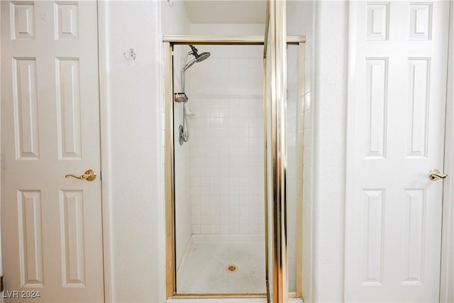 bathroom with a shower with shower door