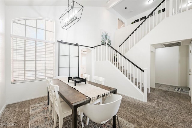 dining space featuring high vaulted ceiling, carpet floors, a barn door, and beamed ceiling