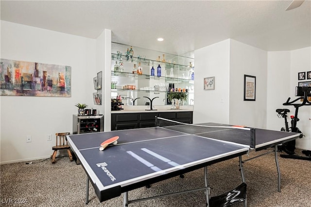 recreation room with carpet flooring and bar