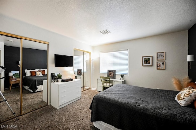 carpeted bedroom featuring a textured ceiling