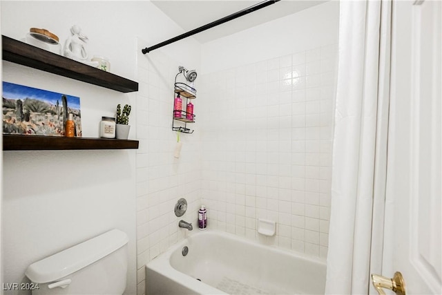 bathroom featuring shower / bath combo with shower curtain and toilet