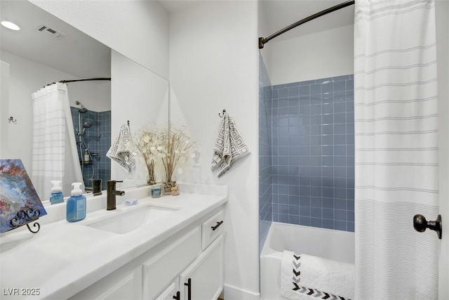 bathroom featuring vanity and shower / bath combination with curtain