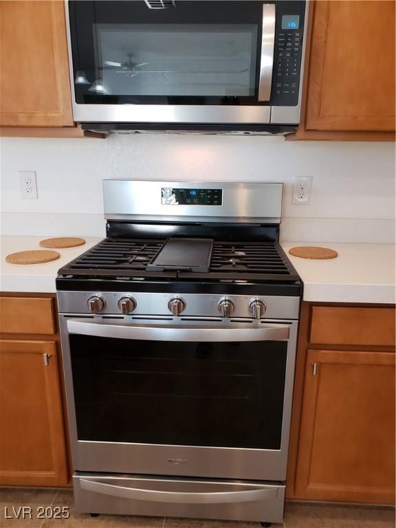 kitchen featuring tile patterned flooring and appliances with stainless steel finishes