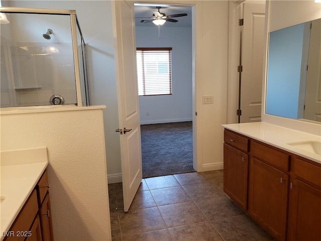 bathroom with walk in shower, vanity, ceiling fan, and tile patterned flooring