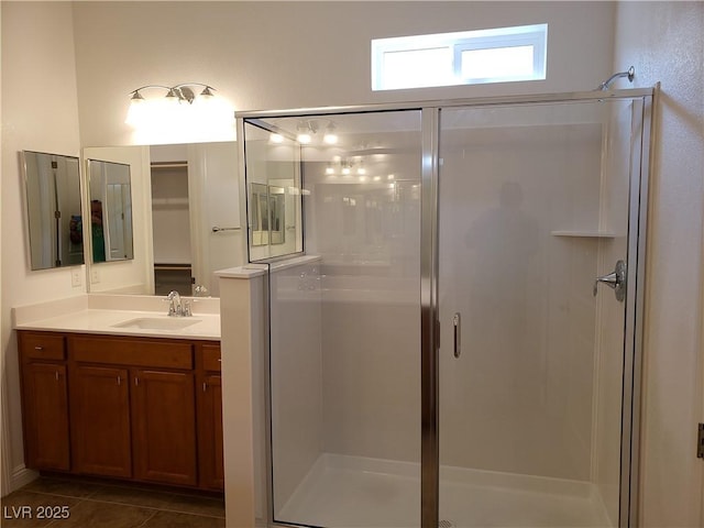 bathroom with tile patterned flooring, vanity, and an enclosed shower