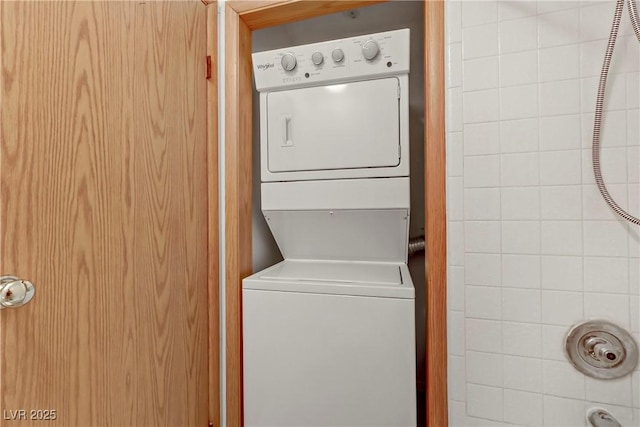 laundry area featuring stacked washer / dryer