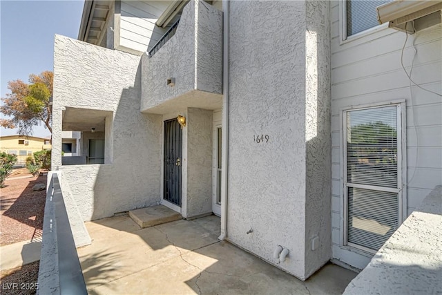 doorway to property with a patio area