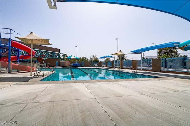 view of pool with a patio area and a water slide