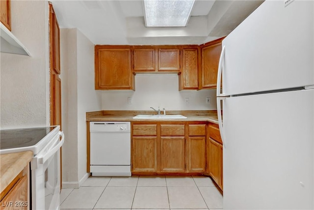 kitchen featuring range hood, white appliances, sink, and light tile patterned floors