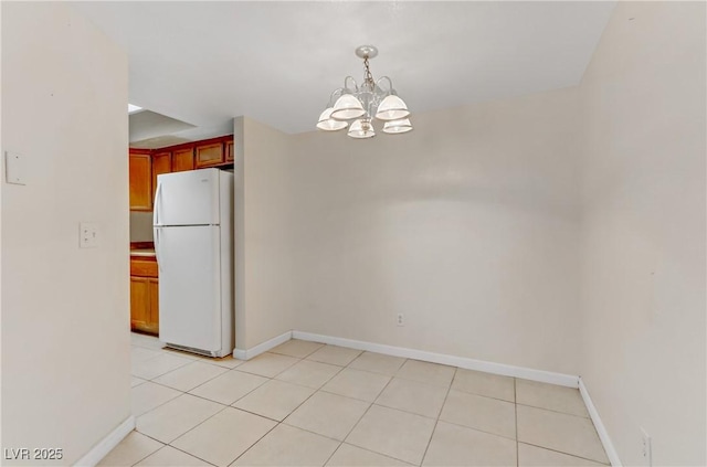 unfurnished dining area with light tile patterned flooring and a notable chandelier