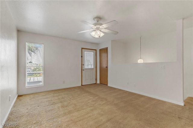 empty room featuring light carpet and ceiling fan