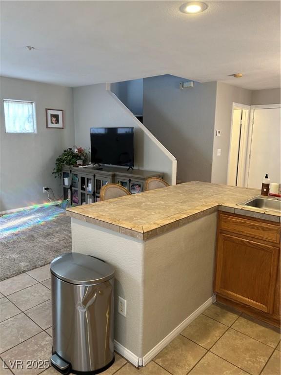 kitchen featuring sink and light tile patterned floors