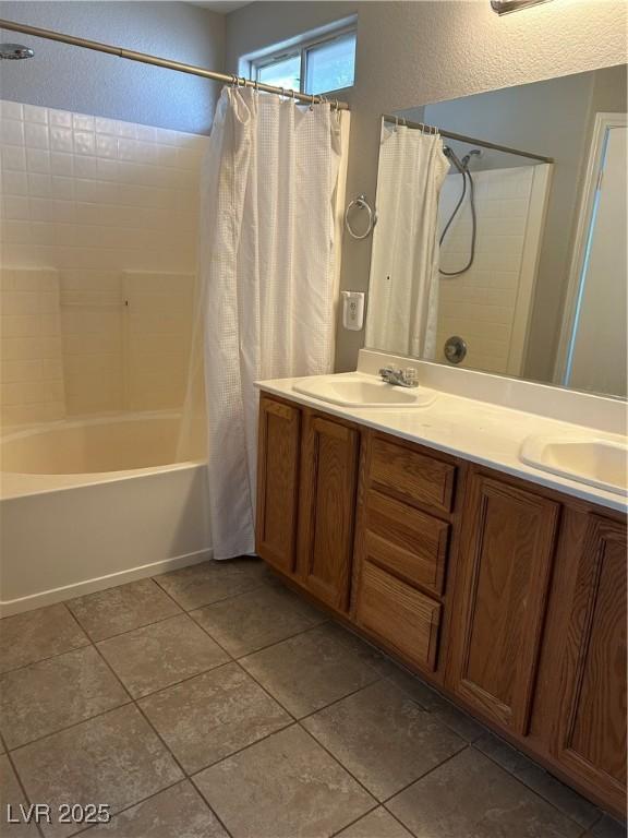 3025 Sunrise Bay Ave, North Las Vegas, NV 89031 - full bath featuring shower / tub combo with curtain, tile patterned floors, and double vanity