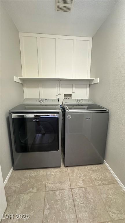 3025 Sunrise Bay Ave, North Las Vegas, NV 89031 - washroom with washing machine and dryer, baseboards, and cabinet space