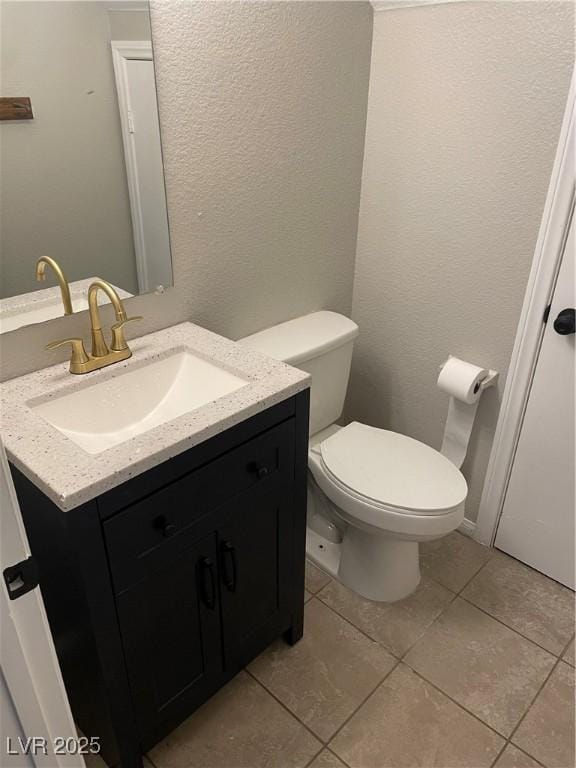 3025 Sunrise Bay Ave, North Las Vegas, NV 89031 - bathroom with vanity, toilet, tile patterned flooring, and a textured wall