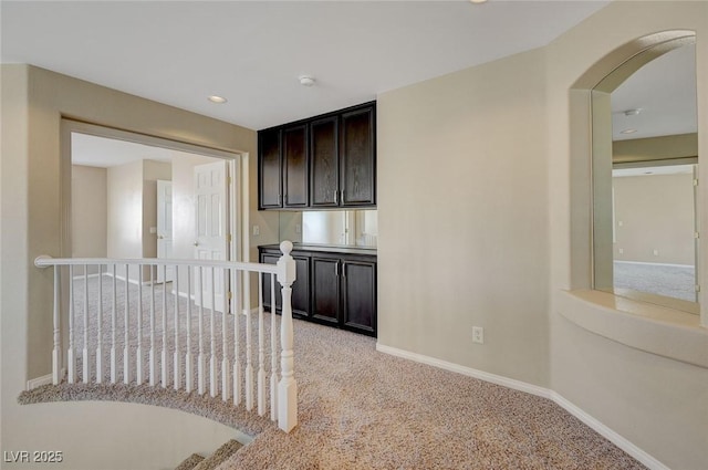 kitchen with light carpet and dark brown cabinets