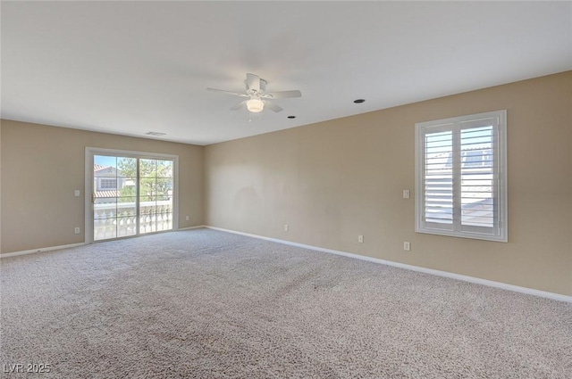 empty room with carpet flooring, ceiling fan, and a healthy amount of sunlight