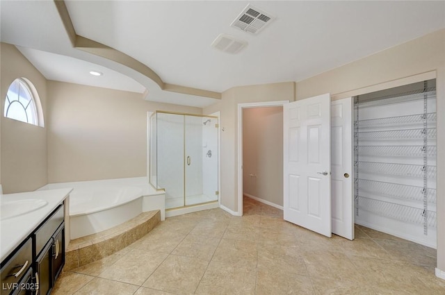 bathroom with tile patterned flooring, vanity, and shower with separate bathtub