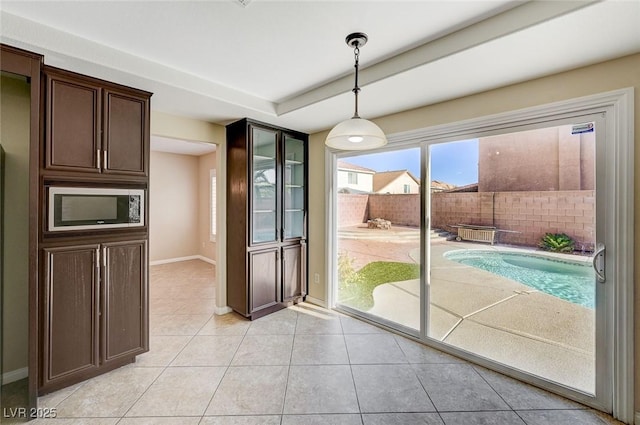 unfurnished dining area featuring light tile patterned floors