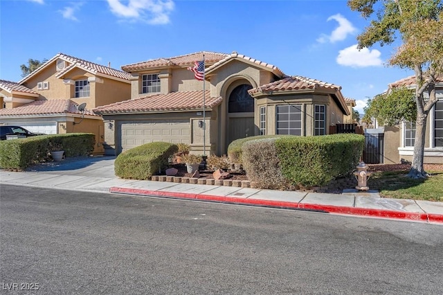 mediterranean / spanish-style house with a garage