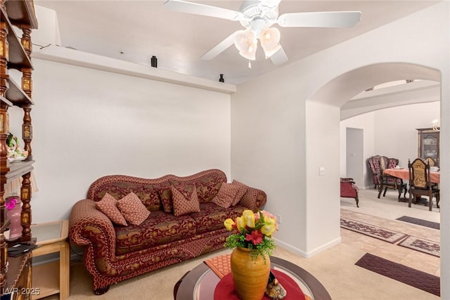 living room featuring light colored carpet and ceiling fan