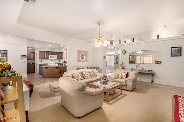 living room featuring light colored carpet and ceiling fan