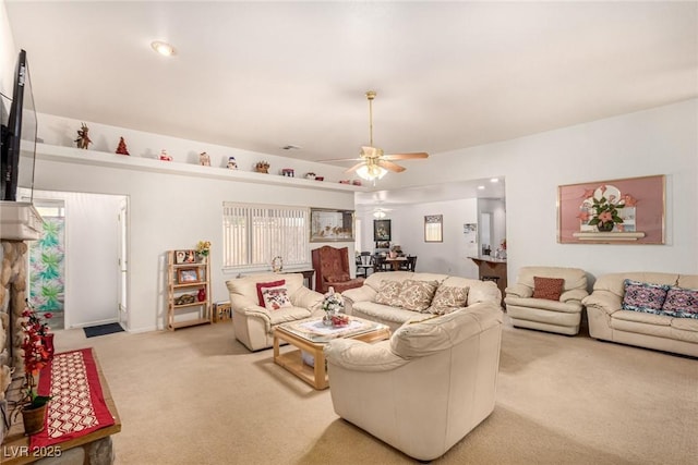 carpeted living room featuring ceiling fan