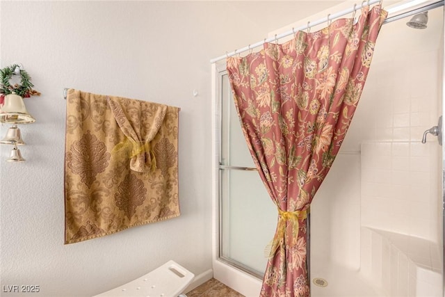 bathroom with tiled shower