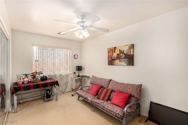 living room featuring carpet and ceiling fan