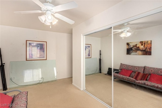 carpeted living room with ceiling fan