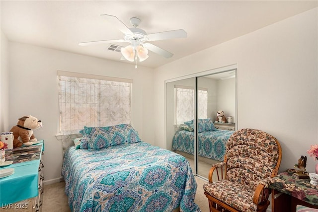 carpeted bedroom featuring ceiling fan and a closet