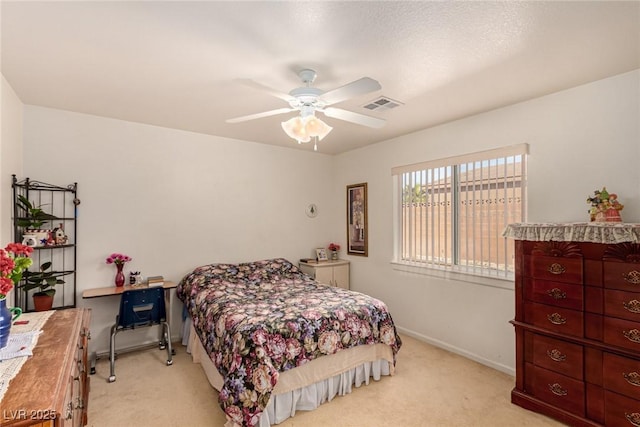 bedroom featuring ceiling fan and light carpet