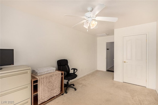 carpeted home office with ceiling fan