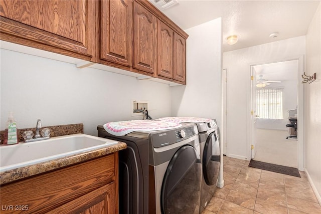 laundry area with cabinets, independent washer and dryer, ceiling fan, and sink