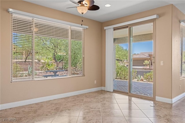 entryway with plenty of natural light, ceiling fan, and light tile patterned flooring