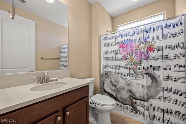 bathroom with vanity, toilet, and curtained shower