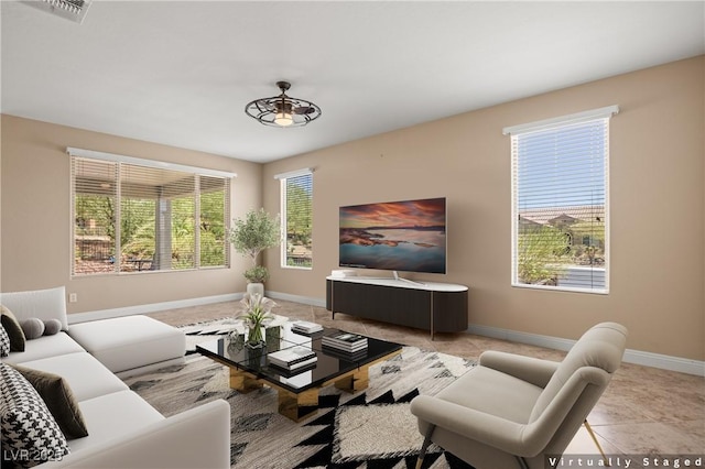 tiled living room with ceiling fan