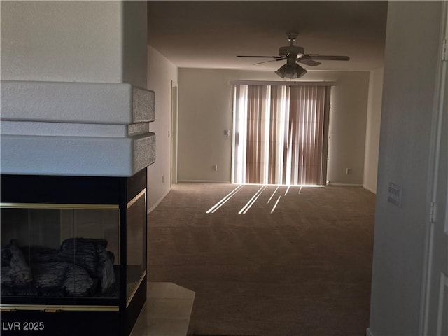 living room with ceiling fan and dark carpet