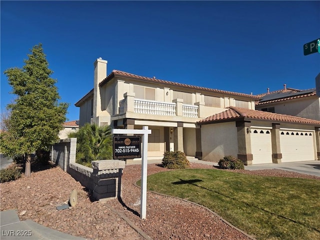 mediterranean / spanish-style home featuring a balcony and a front lawn