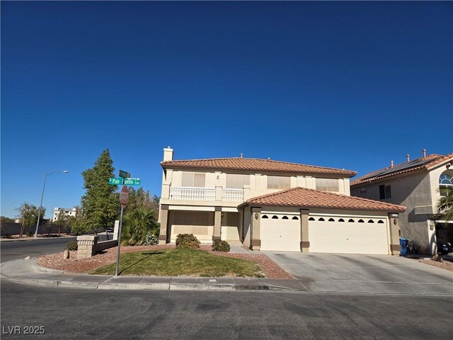 mediterranean / spanish house with a balcony and a garage