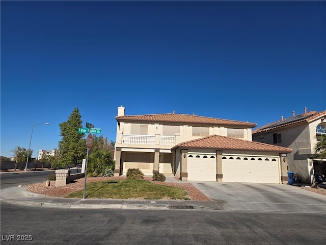 mediterranean / spanish home with a garage and a balcony