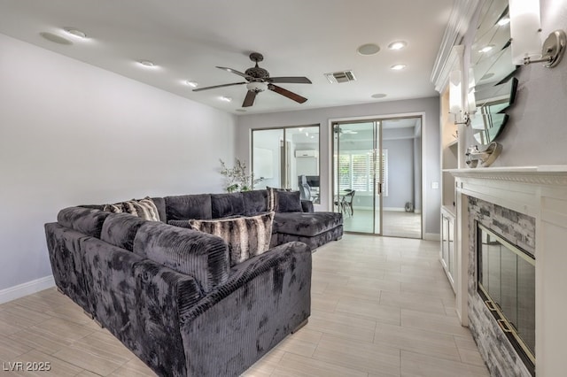 living room with ceiling fan and a fireplace