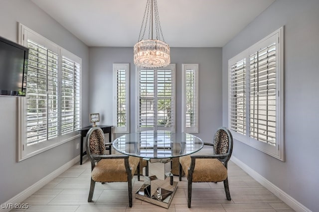 dining room with a healthy amount of sunlight and a notable chandelier