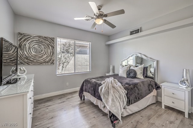 bedroom with ceiling fan and light hardwood / wood-style floors