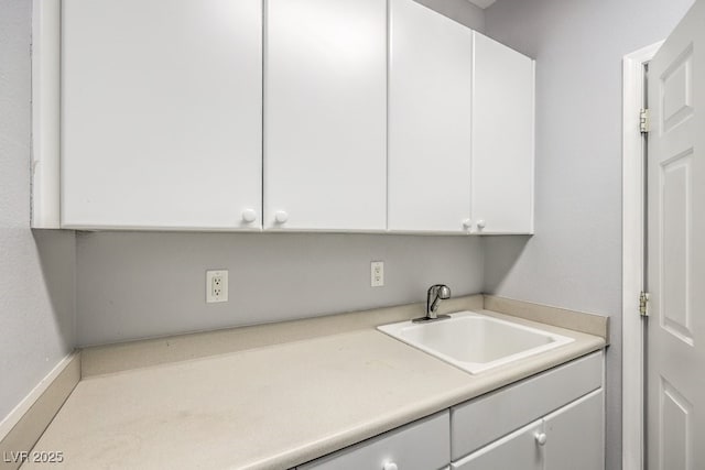 clothes washing area featuring sink