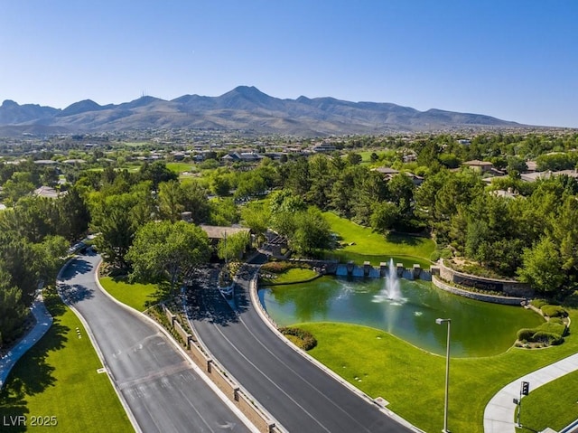 drone / aerial view featuring a water and mountain view